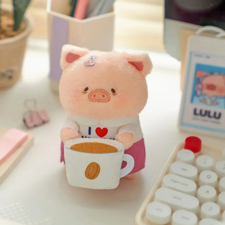 Plush piggy keychain holding a coffee cup, red heart shirt detail.