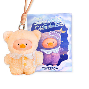 Plush keychain featuring a small pig in a fuzzy peach outfit with lace collar in front of a nighttime illustrated card