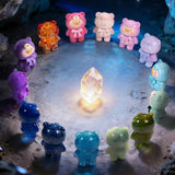 LuLu The Piggy - Mini Teddy Ore Series Blind Bag featuring translucent and textured bear figures arranged around a glowing crystal by LuLu The Piggy