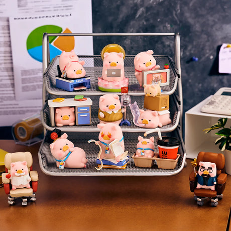 Piggy blind box figure set inside a tray with office supplies and desk items