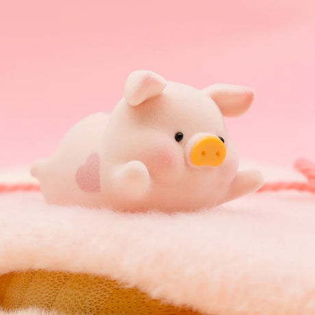 LuLu the Piggy Original Series 2 figure 6 with soft texture and pink heart detail on pale pink fuzzy surface with pink background