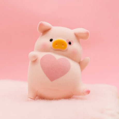 LuLu the Piggy Original Series 2 figure 8 with yellow snout and large pink heart on soft fuzzy surface with pink background