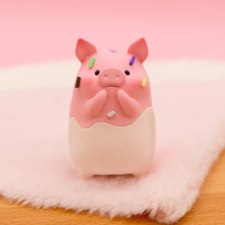 LuLu the Piggy Original Series 2 figure 9 in chocolate-dipped design with colorful sprinkles on soft pink fabric surface