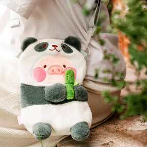 Soft LuLu The Piggy panda cross-body bag with bamboo detail, worn by person sitting outdoors, gallery image 1
