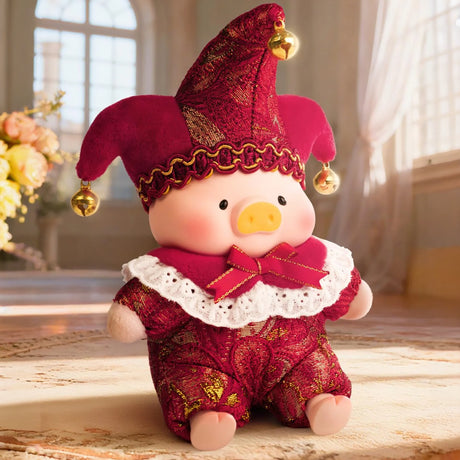 Plush pig doll in ornate red and gold jester costume with lace collar and bell-adorned hat sitting indoors by window