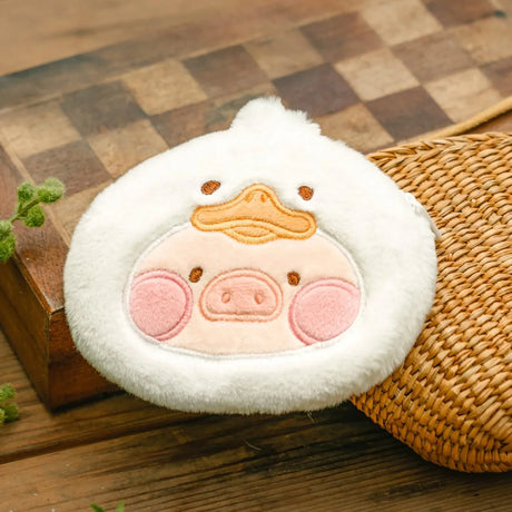 LuLu The Piggy Animal Party Pouch in duck design with pig face, placed on wooden surface and woven mat, gallery 1