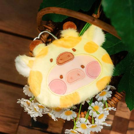 Soft LuLu The Piggy Animal Party Pouch featuring a giraffe pattern with plush texture, displayed with white flowers, gallery position 1