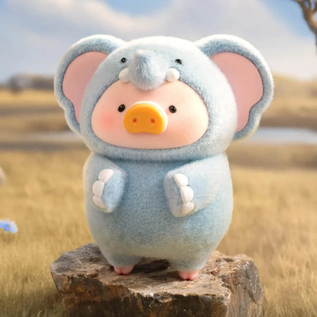 LuLu The Piggy figure dressed in a soft blue elephant costume standing on a rock in outdoor natural setting, Animal Party Blind Box gallery 1