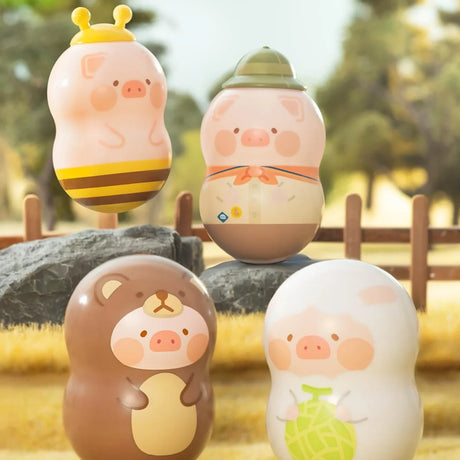 Four LuLu The Piggy desk wobblers in unique cosplayer outfits posed outdoors on rocks, gallery position 1