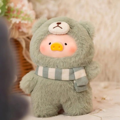 Green plush piggy pal with striped scarf and small pouch detail, stitched face