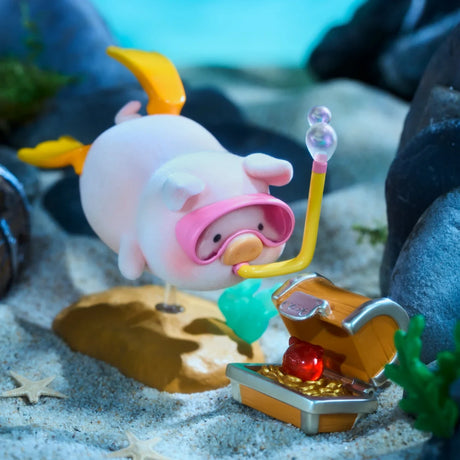 A toy pig wearing a snorkel and swim fins explores under the sea near an open treasure chest with gold and a red gem, from the LuLu The Piggy - Ocean Blind Box by LuLu The Piggy.