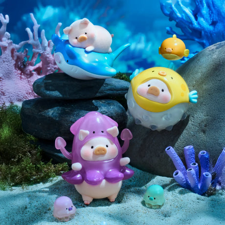 LuLu The Piggy - Ocean Blind Box figures from LuLu The Piggy are dressed as sea creatures and displayed underwater with toy fish, coral, and rocks for a playful ocean scene.