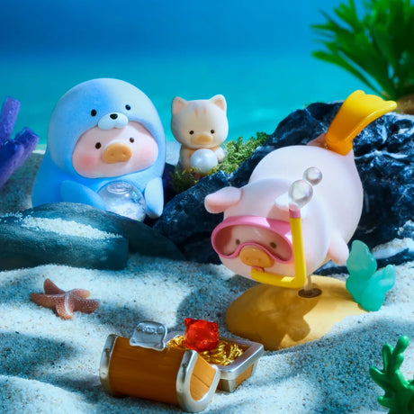 Three adorable LuLu The Piggy - Ocean Blind Box figurines by LuLu The Piggy are underwater: one in a seal costume, another with a snorkel finds a treasure chest, while a small cat sits among rocks and plants.