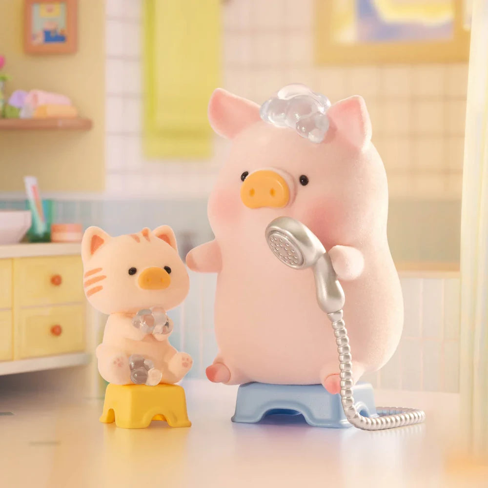 LuLu The Piggy and a plush cat sit on stools in the bathroom, pretending to shower with a toy showerhead and covered in bubbles—a perfect scene for fans of the LuLu the Piggy - Stay With You Blind Box by LuLu The Piggy.
