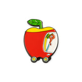 Red apple-shaped enamel pin with green stem and cartoon figure