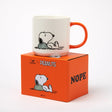 White ceramic mug with orange handle and Snoopy holding a bird graphic.