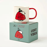 White Snoopy mug with Snoopy in red quilted jacket and red handle