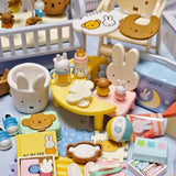 Close-up baby room table with diapers, bottles, bunny figurines, and food pieces