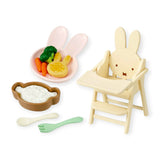 Rabbit high chair with plate of toy food and small wooden utensils