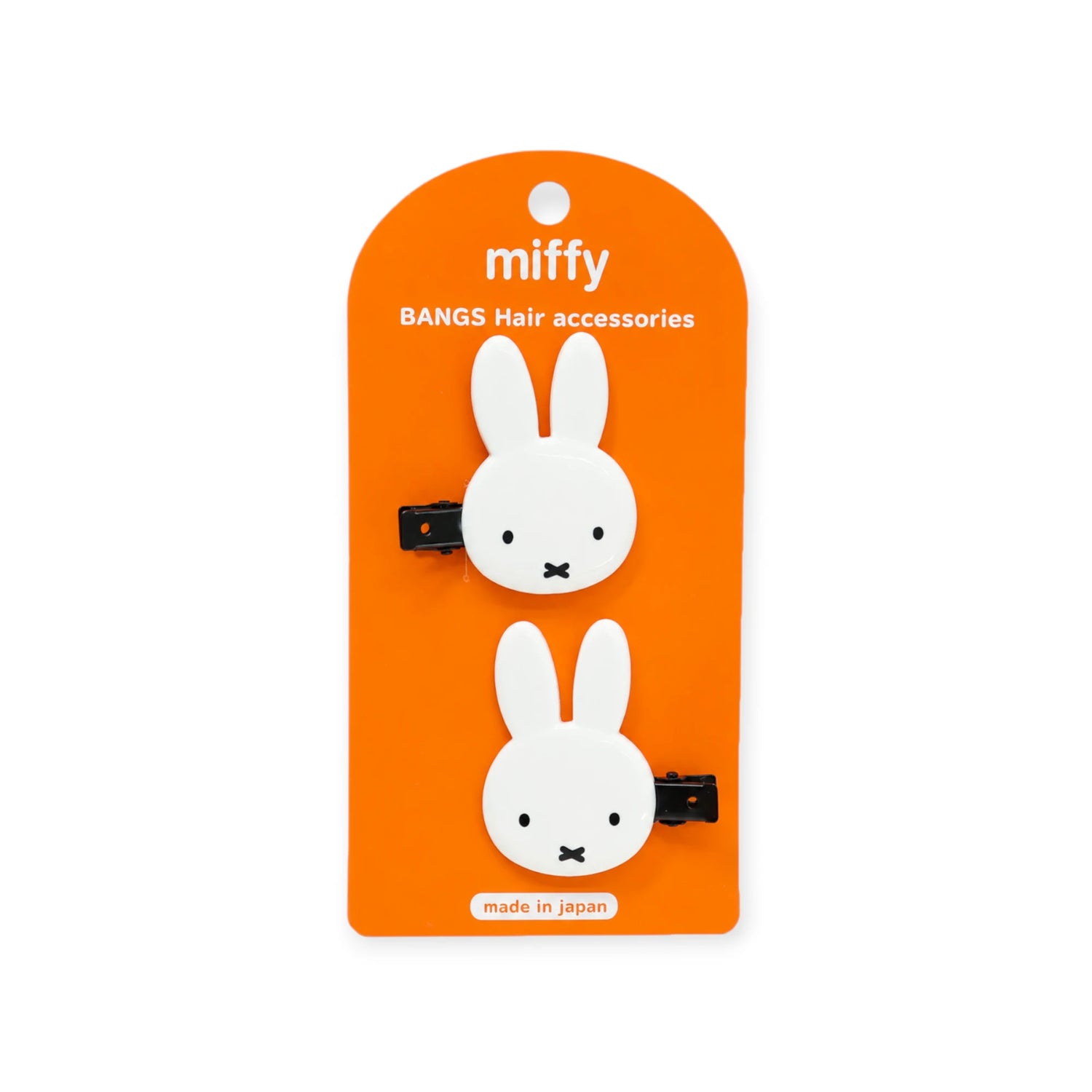Orange package card showing two white bunny hair clip accessories with black snap clips