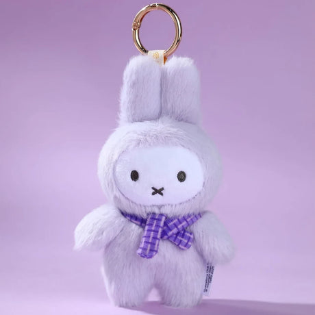 The VIPO x Miffy Macaron 2 Plush Keychain - Blind Box by Miffy features a plush bunny with a purple plaid scarf and gold ring, against a light purple background—ideal for pastel Miffy fans.