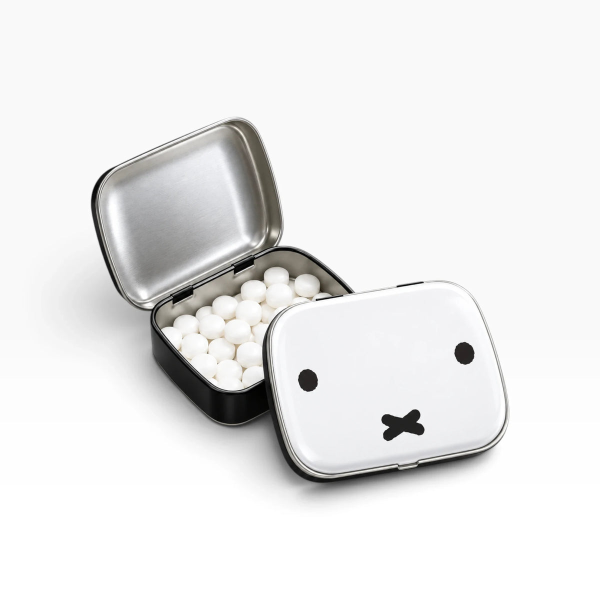 Miffy bunny pill tin open, showing white tablets inside and bunny face on lid