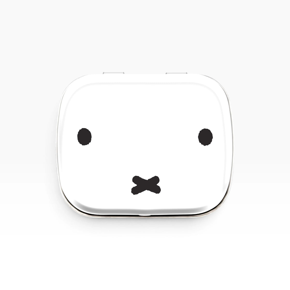 Miffy bunny pill tin with white lid and black bunny face design