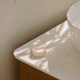 Rabbit-shaped bar soap on a white tray in a bathroom sink