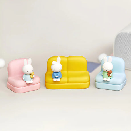 Three colorful mini sofa stands each with a seated Miffy or Dan figure holding teddy bears on soft neutral background