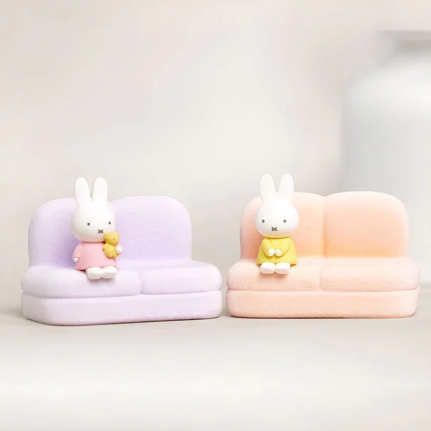 Two phone stand sofas with rabbit figures on lilac and peach seats