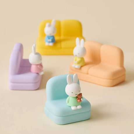 Four pastel mini sofas with seated Miffy and Dan figures wearing colorful outfits on beige background