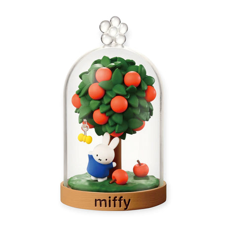 Miffy terrarium dome with green tree, red apples, and a blue rabbit figurine