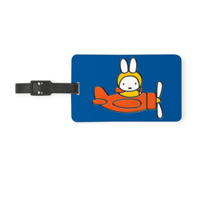Blue Miffy airplane luggage tag with black strap and cartoon rabbit in seat