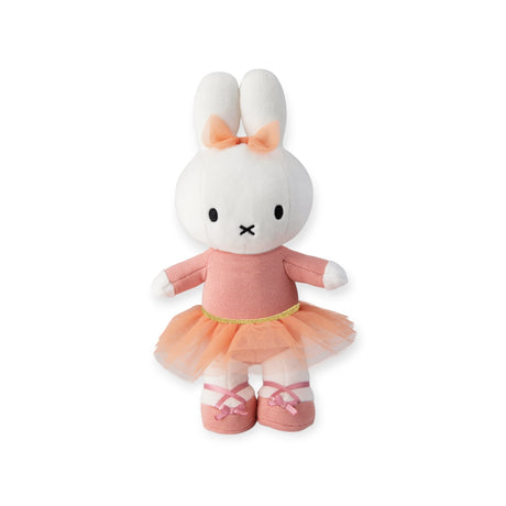 Celebrate Miffy's 70th anniversary with the limited edition Miffy Flower Dress Plush. This charming 23cm toy is designed in a peach dress and ballet shoes, complete with elegant ribbon details and a matching ear bow. Perfect for collectors and fans of whimsical elegance!.