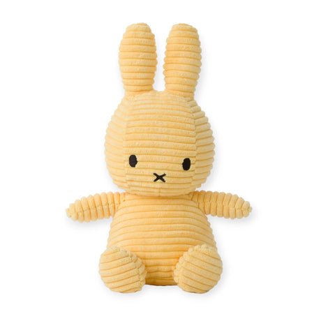 A Miffy Bunny Plush Corduroy in Buttercream, measuring 23 cm, featuring a ribbed texture with long ears and a small black face, is shown sitting upright against a white background and providing hypoallergenic comfort.