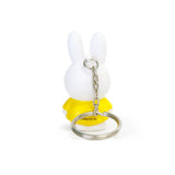 This Miffy Keychain - Classic from Miffy is an adorable accessory showcasing a white rabbit with long ears, dressed in classic yellow, seen from the back.