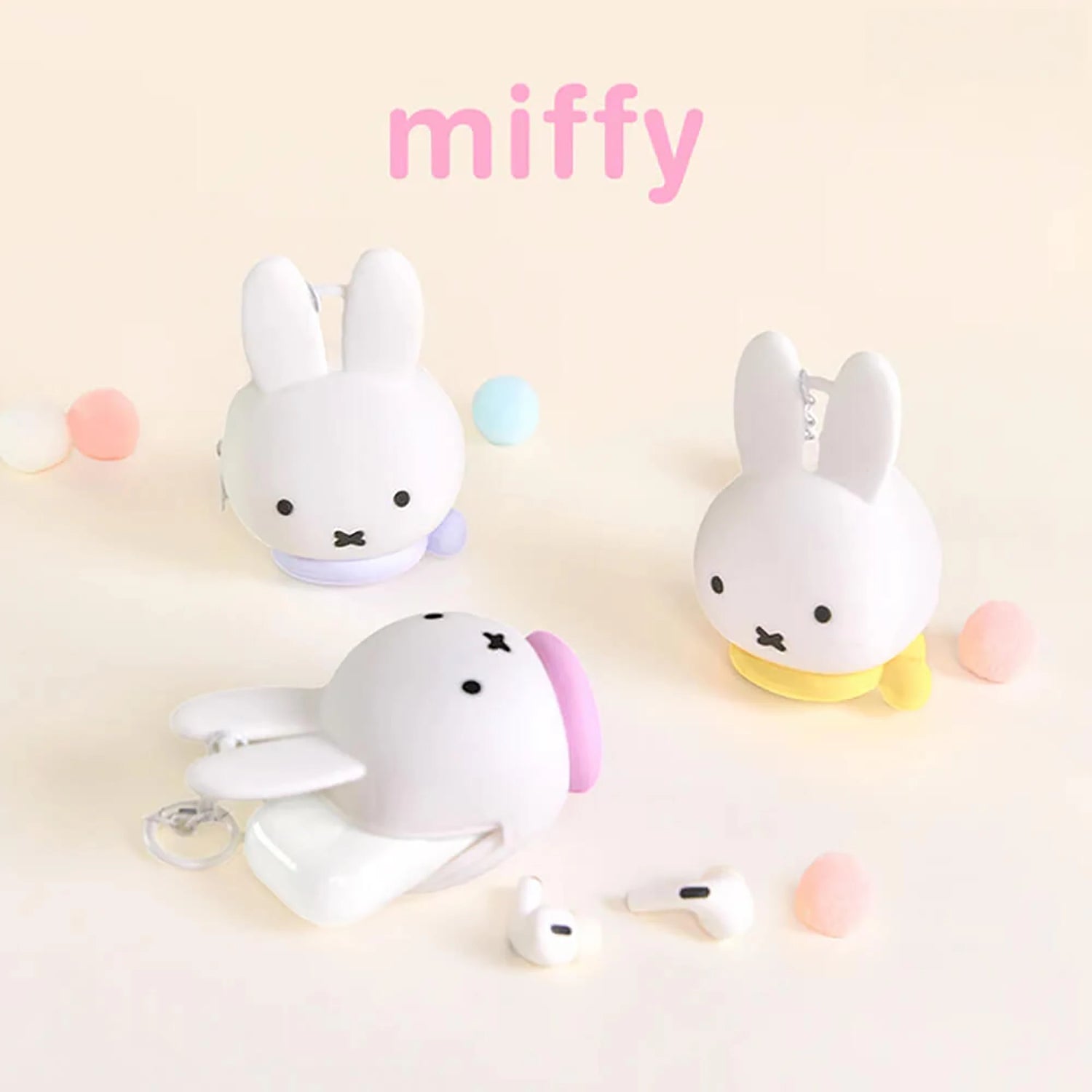 Miffy bunny coin pouch keychains, white plush bunnies with hanging key rings and pastel bases.
