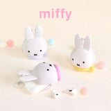 Miffy bunny coin pouch keychains, white plush bunnies with hanging key rings and pastel bases.
