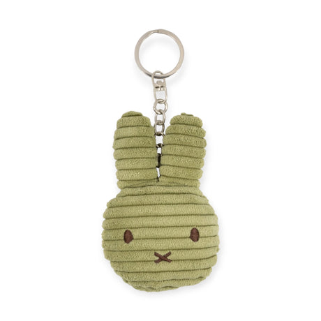 The Miffy Flat Corduroy Keychain in off-white is an eco-friendly, rabbit-shaped accessory with delicate stitched facial details and a sturdy metal keyring.