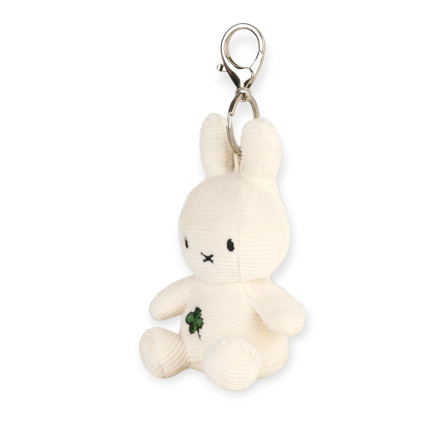 Cream plush bunny keychain facing forward, green four-leaf clover patch