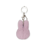 The Miffy Fuzzy Keychain - Lilac by Miffy offers a fluffy, rabbit ear-shaped pinkish key fob attached to a metal ring and clip, combining sustainable design with charm for your everyday essentials.