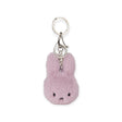 The Miffy Fuzzy Keychain - Lilac, by Miffy, combines an adorable pink and lilac fluffy bunny design with sustainable elements, featuring a metal clip and ring.