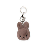 The Miffy Fuzzy Keychain in taupe, featuring a soft, plush texture with a silver ring, inspired by Miffy's beloved character from Bon Ton Toys, adds charm to your keys or bag.