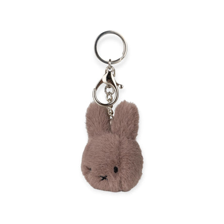 Add whimsy to your accessories with the Miffy Fuzzy Keychain in taupe, featuring a plush rabbit and silver clip, by Bon Ton Toys.