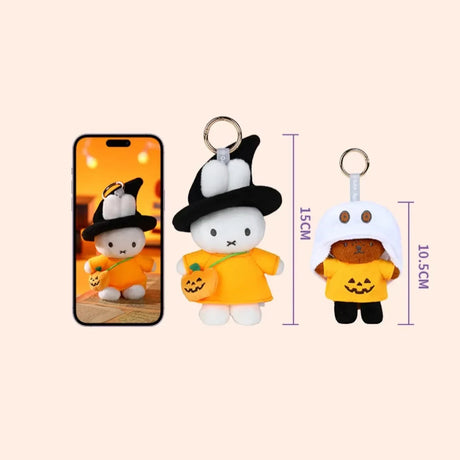 Two Miffy plush keychains wearing Halloween costumes with size comparison and a phone display on peach background