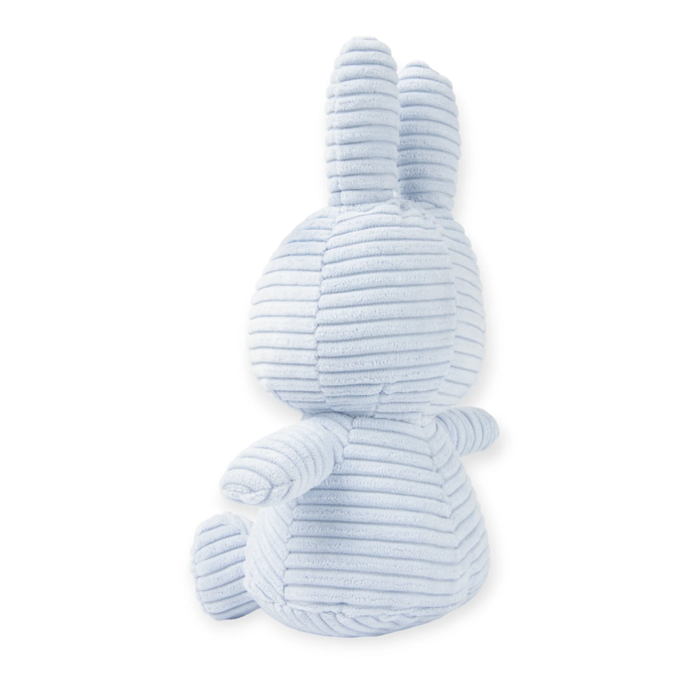 The Miffy Bunny Plush Corduroy - Ice Blue 23cm by Miffy, crafted from recycled polyester, features a soft light blue shade as it sits facing away, accentuating its delicate back and charming ears.