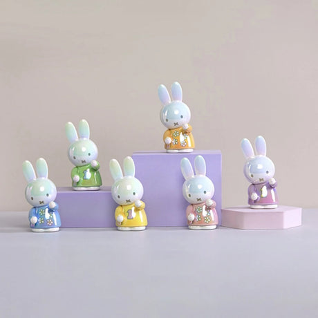 Glossy ceramic Miffy pen tray organisers in pastel green, yellow, blue, orange, pink, and purple floral outfits on pastel platforms
