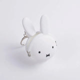 The Miffy Keychain Coin Pouch - White, a rabbit-shaped silicone purse by Miffy, comes with a convenient keychain attachment and is showcased on a plain background.