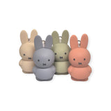 The Miffy Keychains - Powder by Miffy offer a modern twist to the classic minimalist design with four adorable bunny shapes in pastel colors: cream, blue, green, and orange. Each keychain features small black eyes and noses, capturing the charm of the Miffy Bunny Keychains as they are elegantly displayed on a white background.