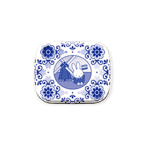 The Miffy Pill Tin - Vintage Nijntje by Miffy features Delft-style blue florals, a windmill, and the Nijntje rabbit with a Dutch flag—ideal for organizing pills or small items on the go.